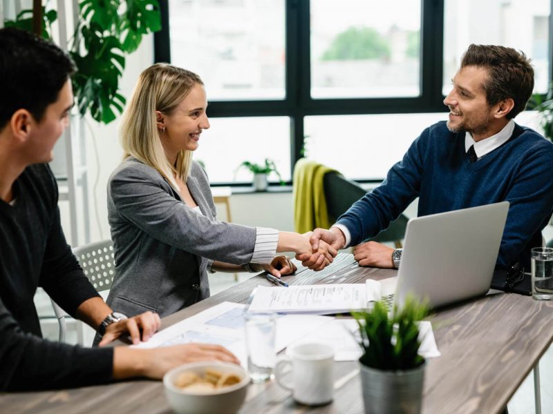 young-happy-couple-meeting-with-financial-advisor-office-woman-is-handshaking-with-agent (1)